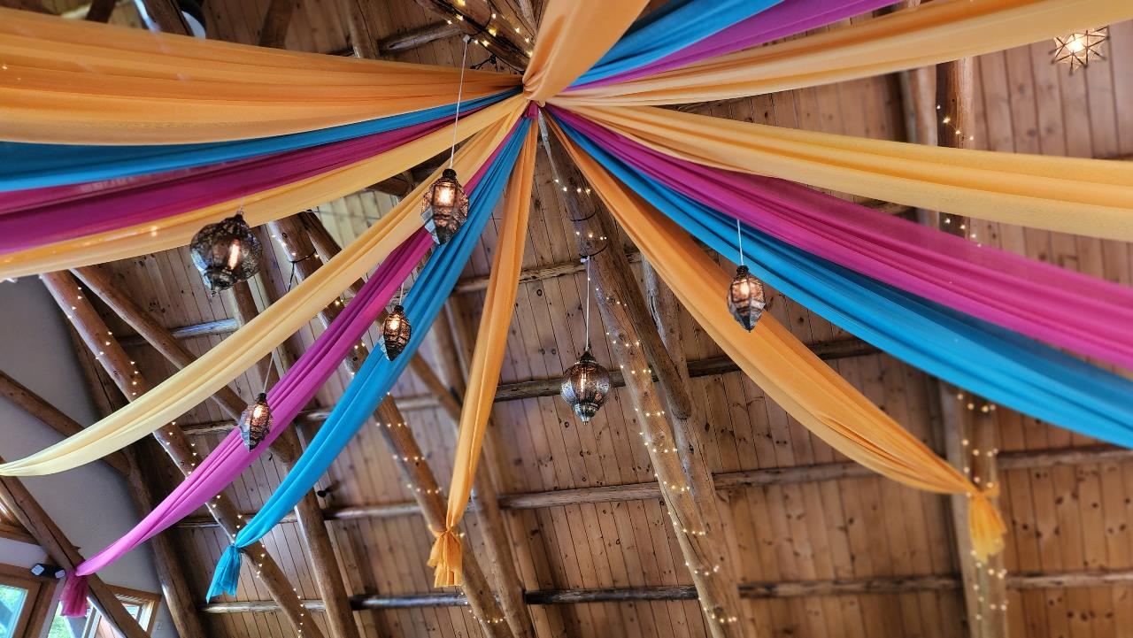 The Barn at Lakefalls interior with colorful drapery and lanterns
